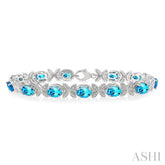 7x5 MM Oval Cut Blue Topaz and 1/10 ctw Round Cut Diamond Semi Precious Bracelet in Sterling Silver