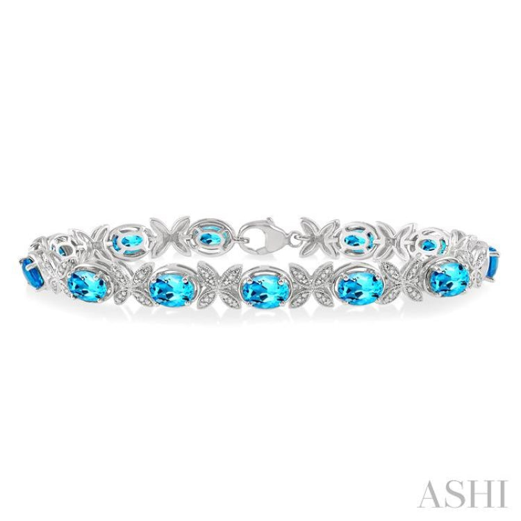 7x5 MM Oval Cut Blue Topaz and 1/10 ctw Round Cut Diamond Semi Precious Bracelet in Sterling Silver