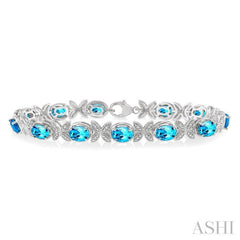 7x5 MM Oval Cut Blue Topaz and 1/10 ctw Round Cut Diamond Semi Precious Bracelet in Sterling Silver