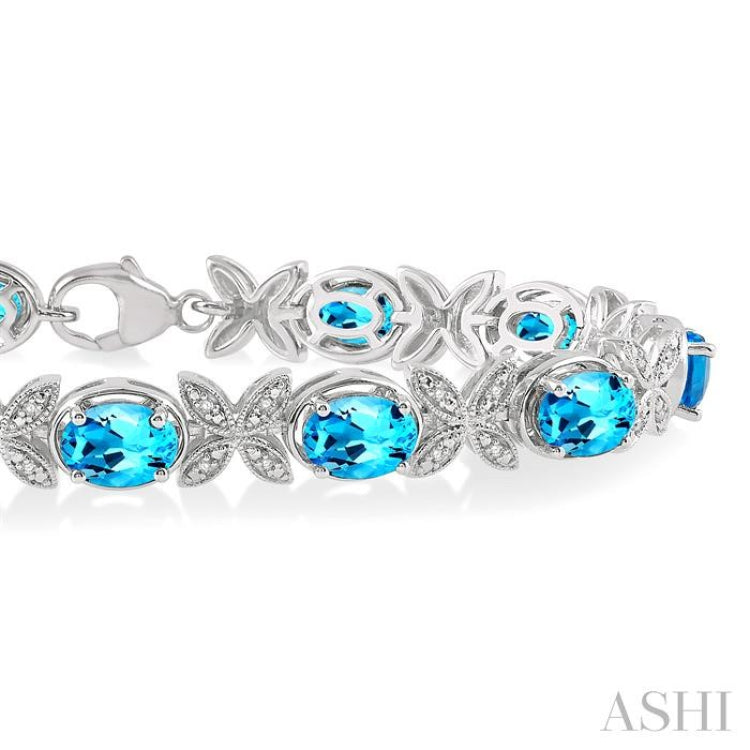 7x5 MM Oval Cut Blue Topaz and 1/10 ctw Round Cut Diamond Semi Precious Bracelet in Sterling Silver