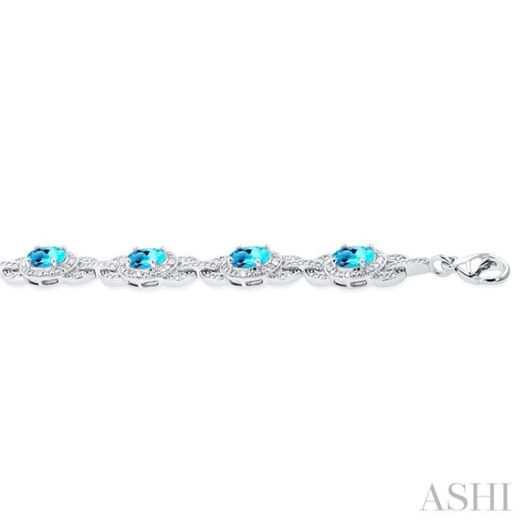 7x5 MM Oval Shape Blue Topaz and 1/10 ctw Round Cut Diamond Semi Precious Bracelet in Sterling Silver
