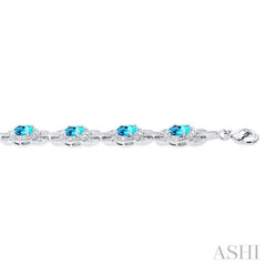 7x5 MM Oval Shape Blue Topaz and 1/10 ctw Round Cut Diamond Semi Precious Bracelet in Sterling Silver