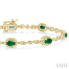 5x3 MM Oval Cut Emerald and 1/20 ctw Single Cut Diamond Bracelet in 10K Yellow Gold